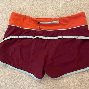 Size 6 2.5” Speed Up Lululemon shorts! Blue, orange, and maroon